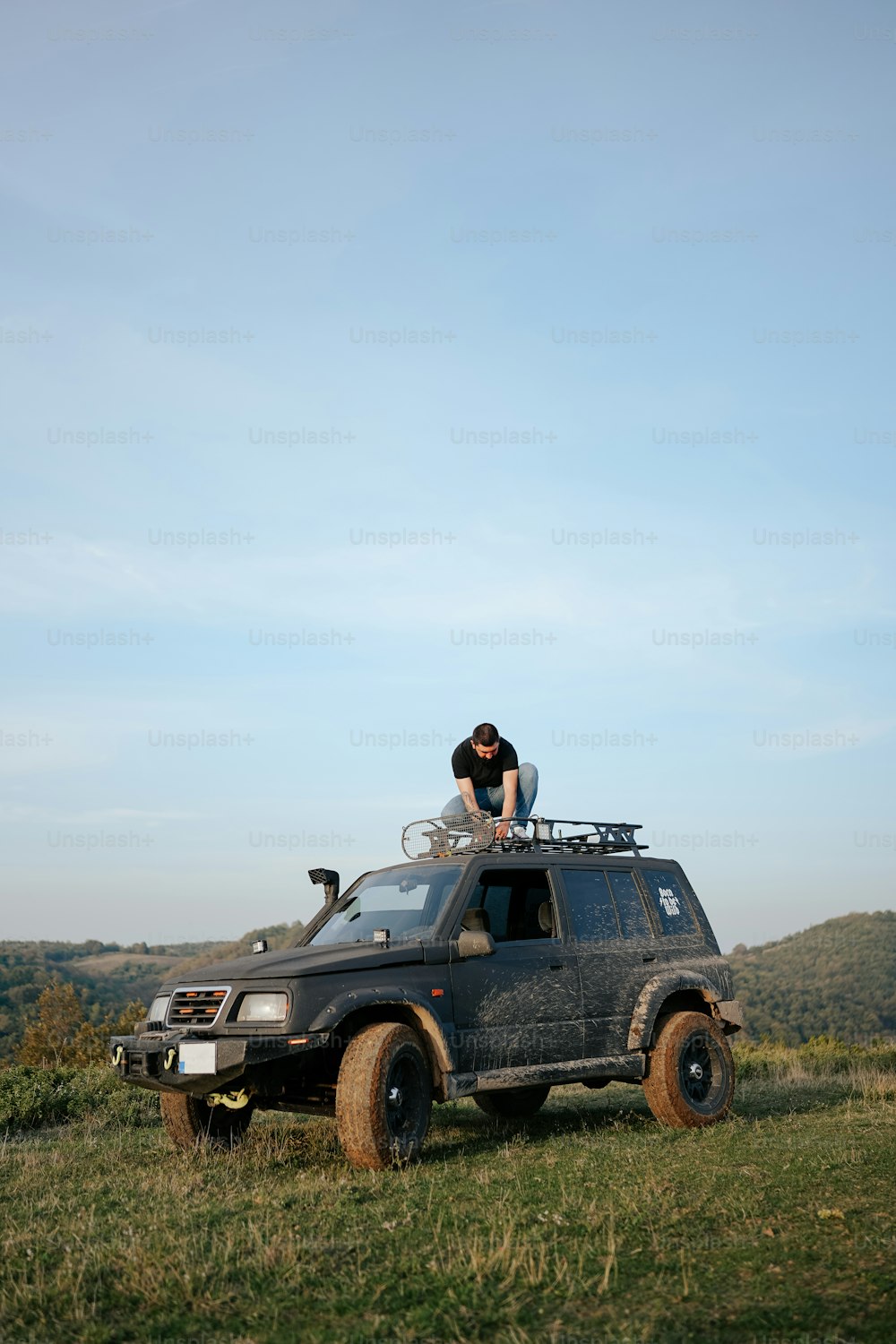 a person on top of a vehicle in a field
