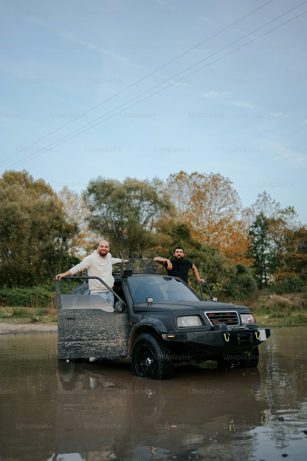 a couple of people standing in the back of a truck