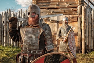 two men dressed in medieval armor standing next to each other