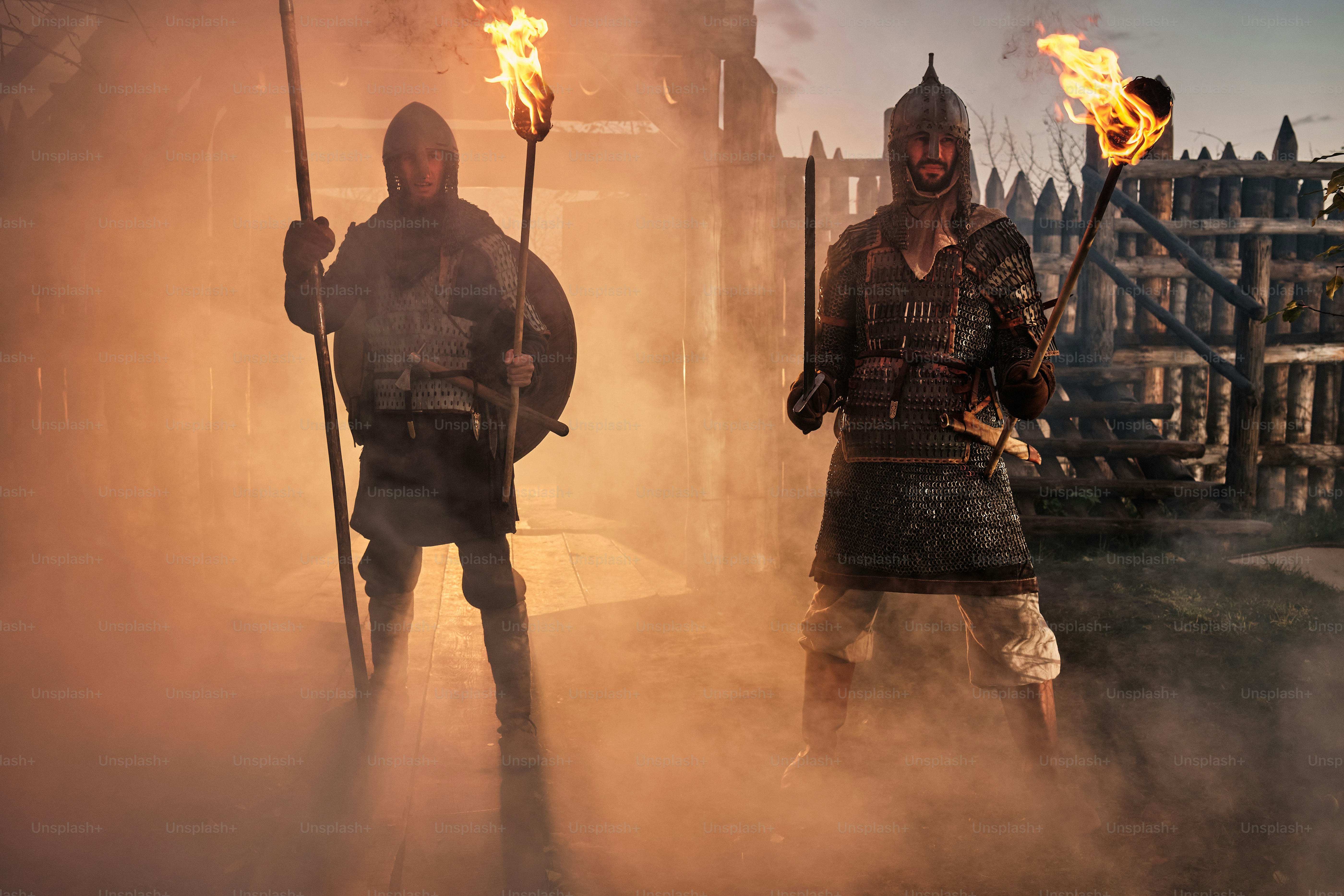 a group of men standing next to each other holding torches