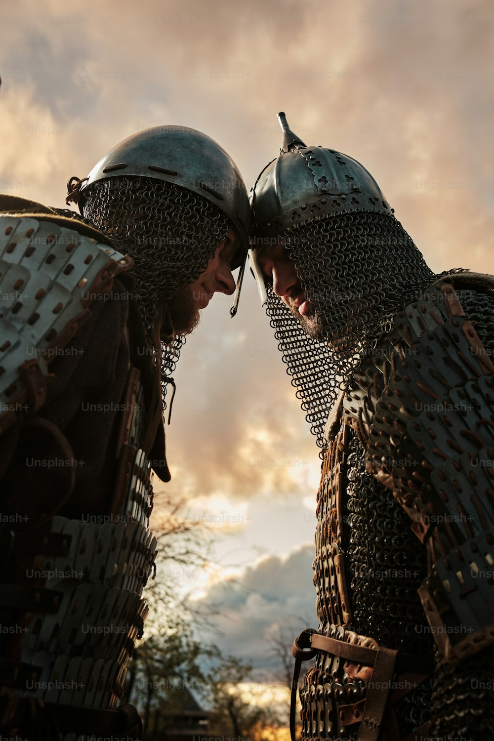 a couple of men in armor standing next to each other