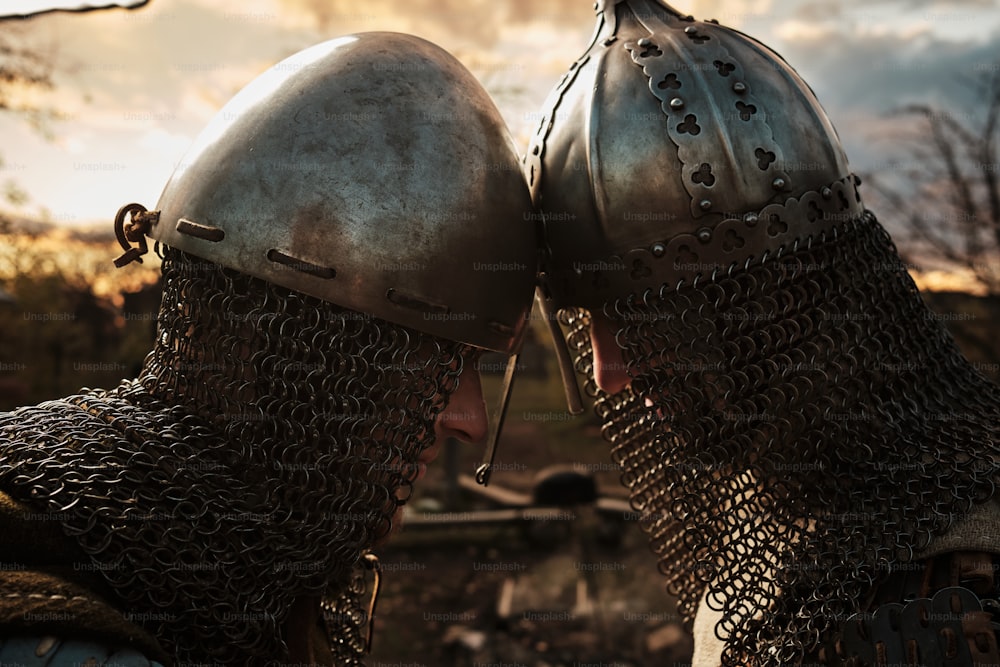 a couple of men in armor kissing each other