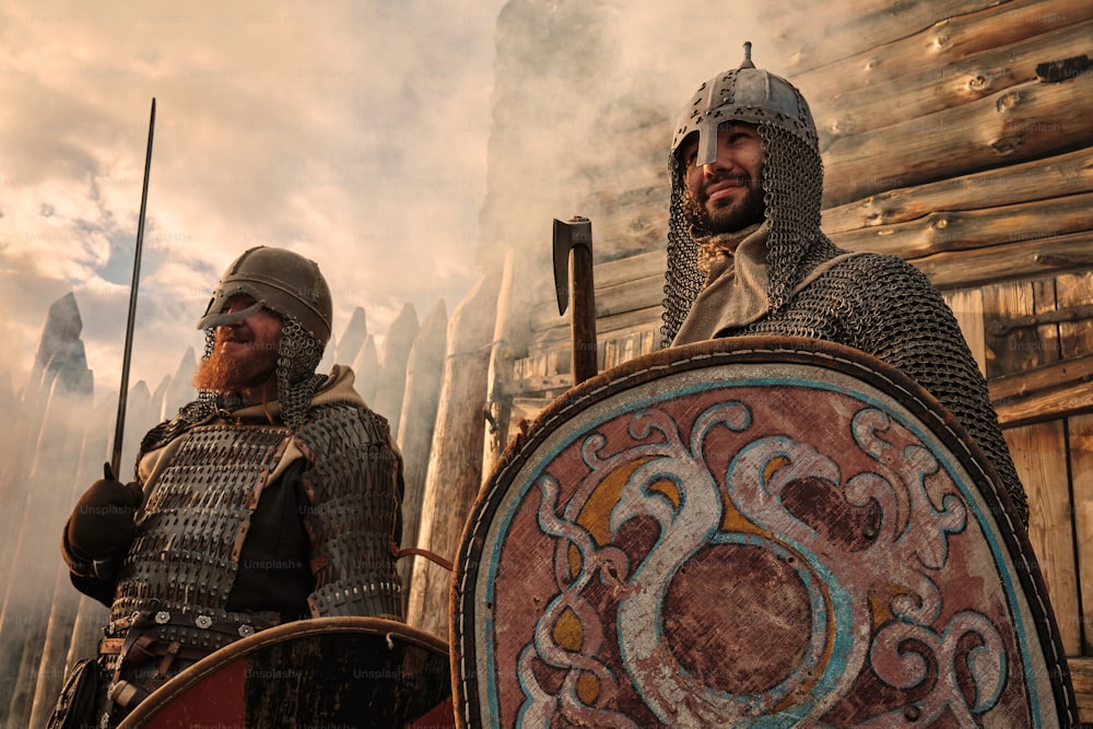 a couple of men in armor standing next to each other