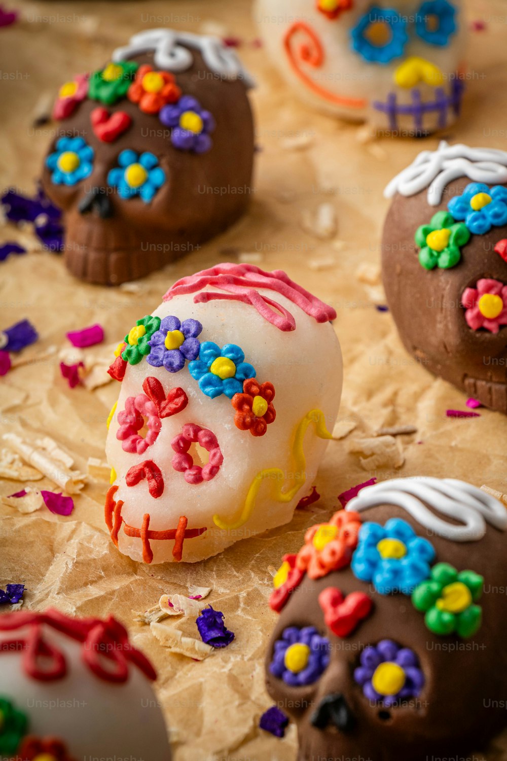 a table topped with chocolate covered donuts covered in sprinkles