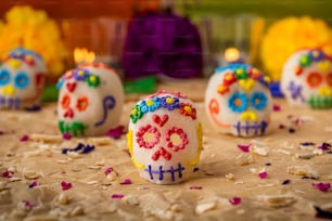 a group of decorated sugar skulls sitting on top of a table