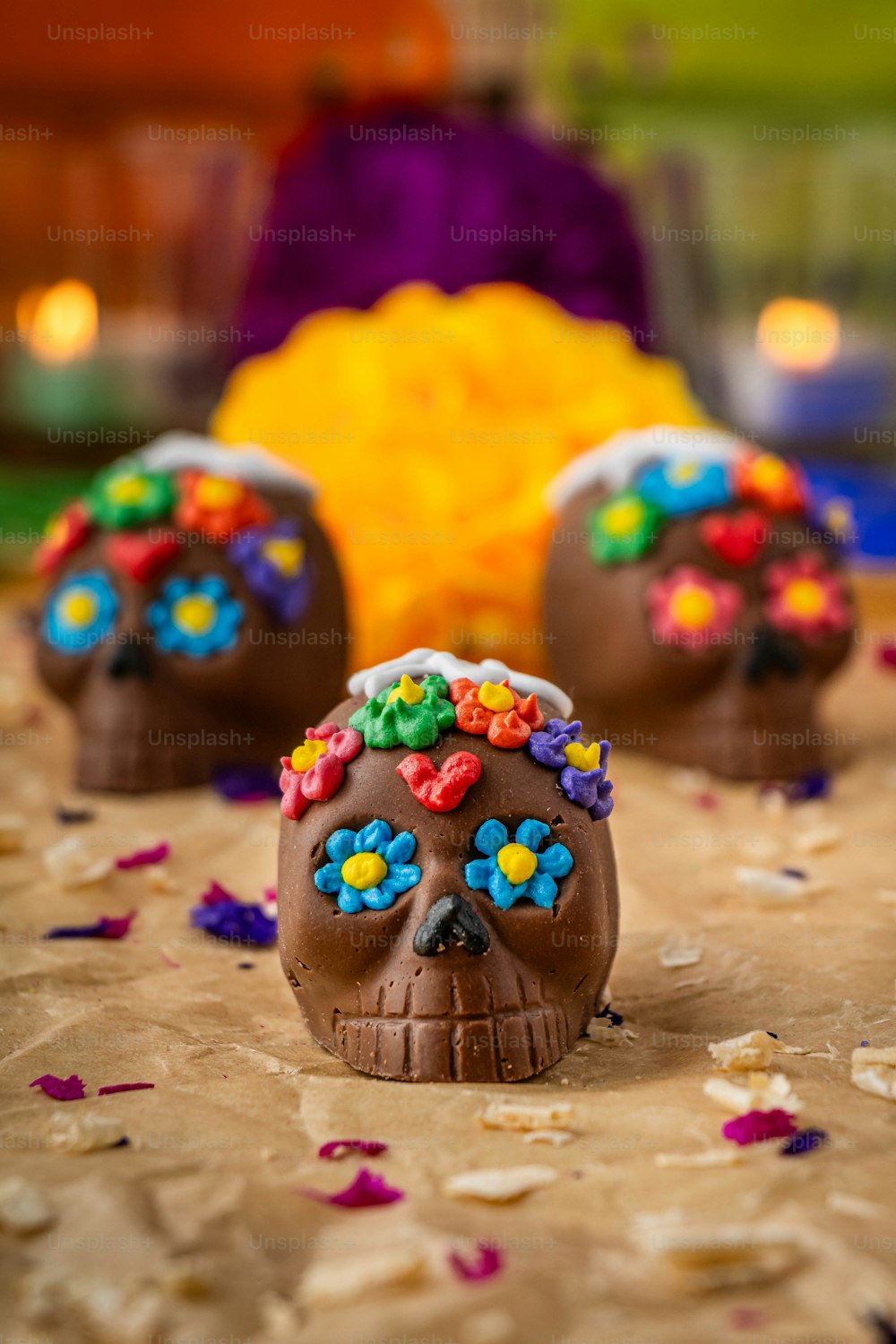 a table topped with three chocolate covered skulls