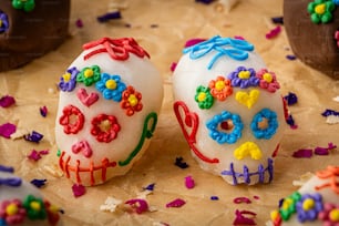 two decorated sugar skulls sitting on top of a table