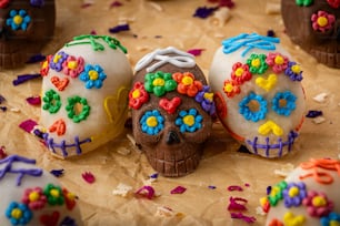 three decorated sugar skulls sitting on top of a table