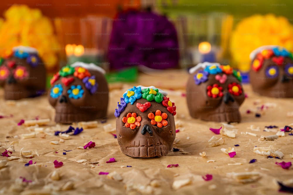 a table topped with chocolate covered skulls covered in candy