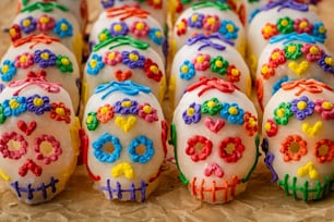 a group of decorated sugar skulls sitting on top of a table