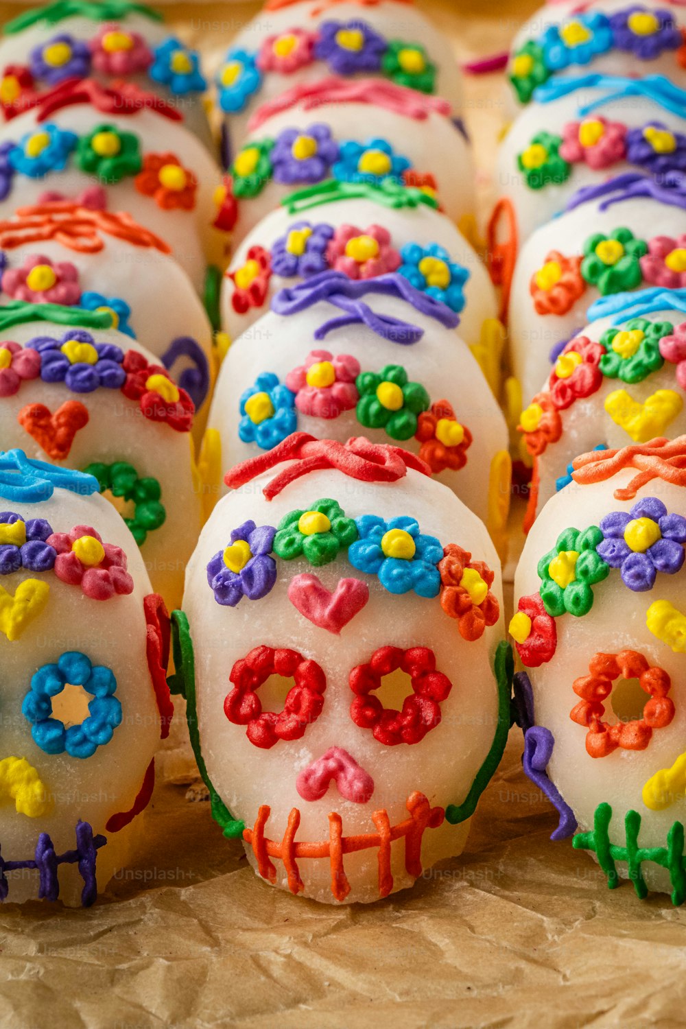 a close up of a tray of decorated donuts