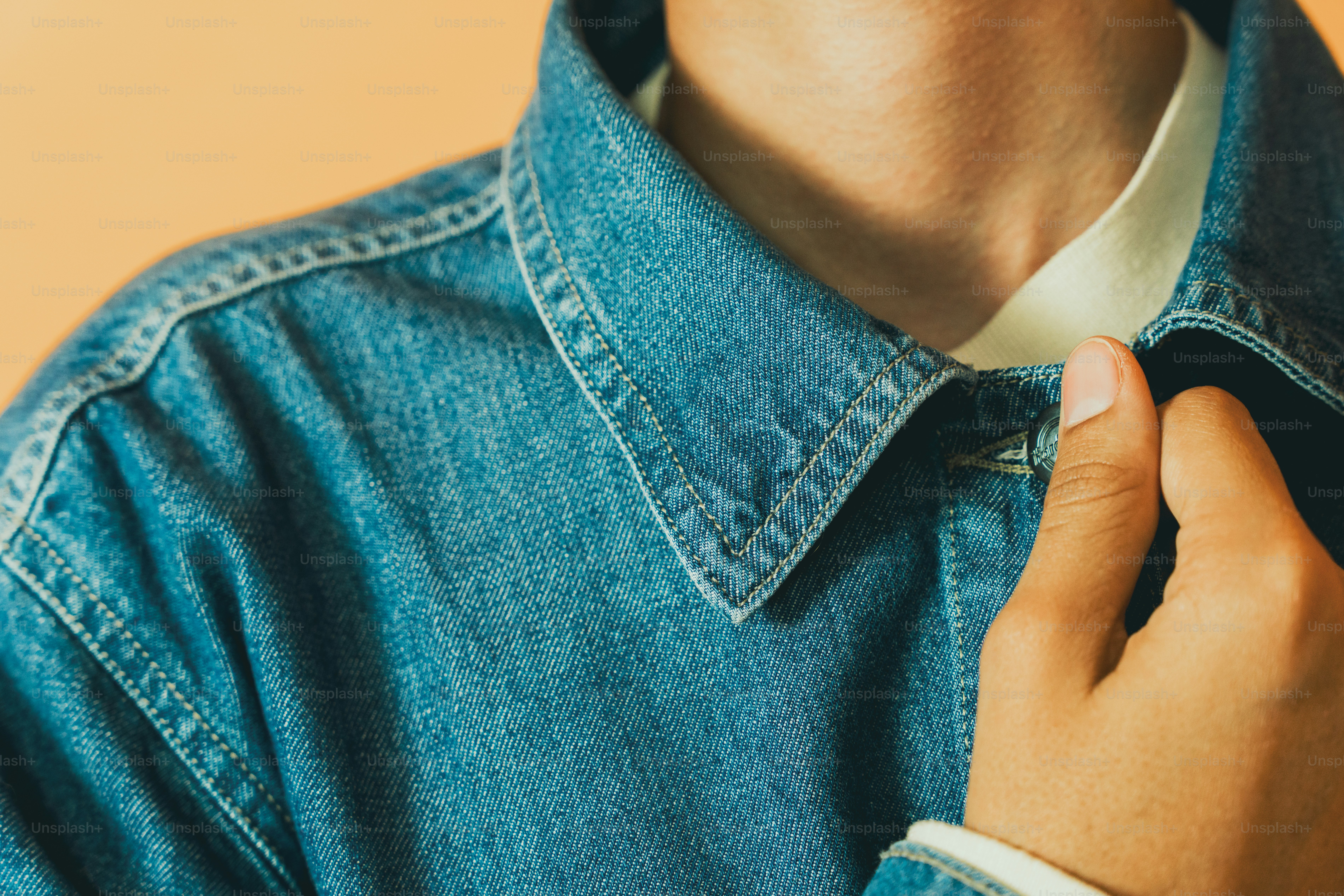 a close up of a person wearing a jean jacket
