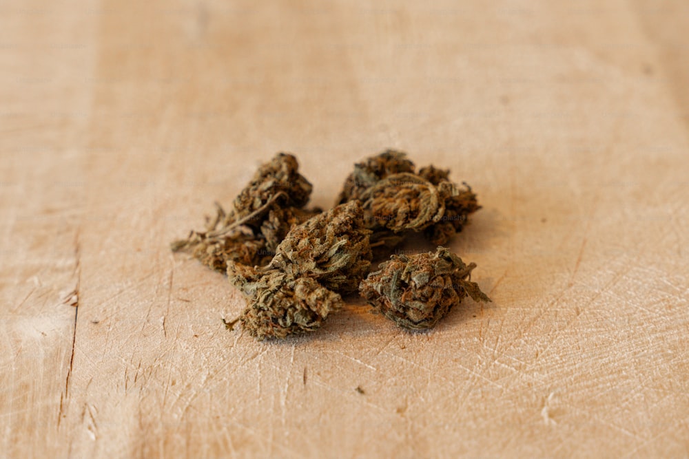 a pile of dried weed sitting on top of a wooden table