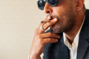 a man in a suit smoking a cigarette