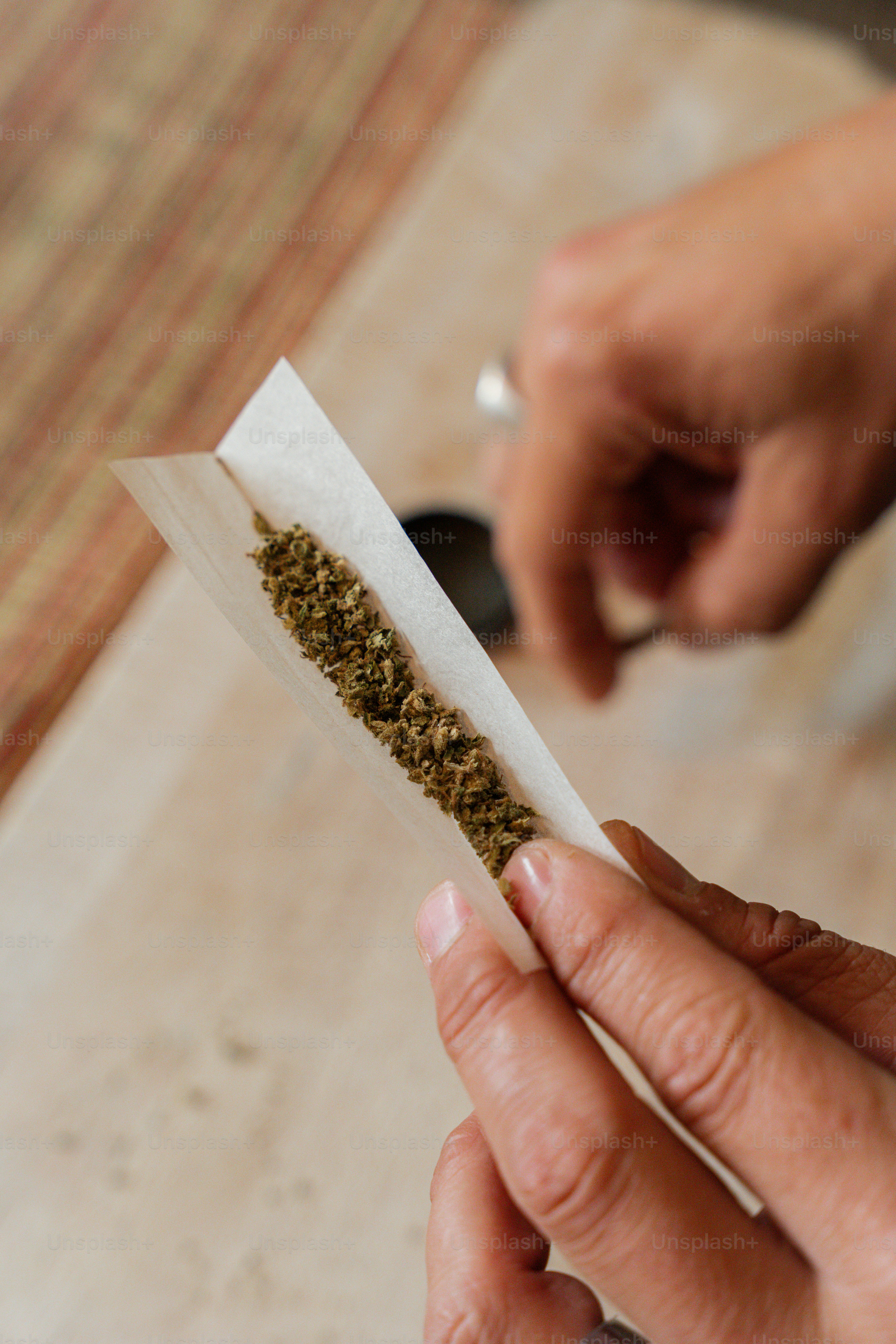 a person holding a piece of paper with a mixture of spices in it