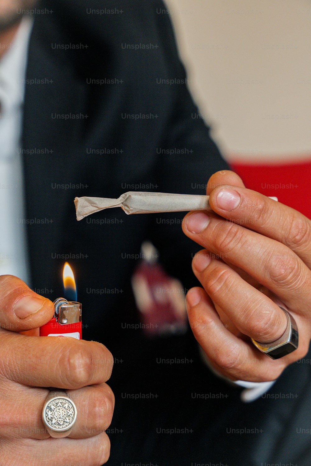 a man holding a lighter and a lighter lighter in his hand