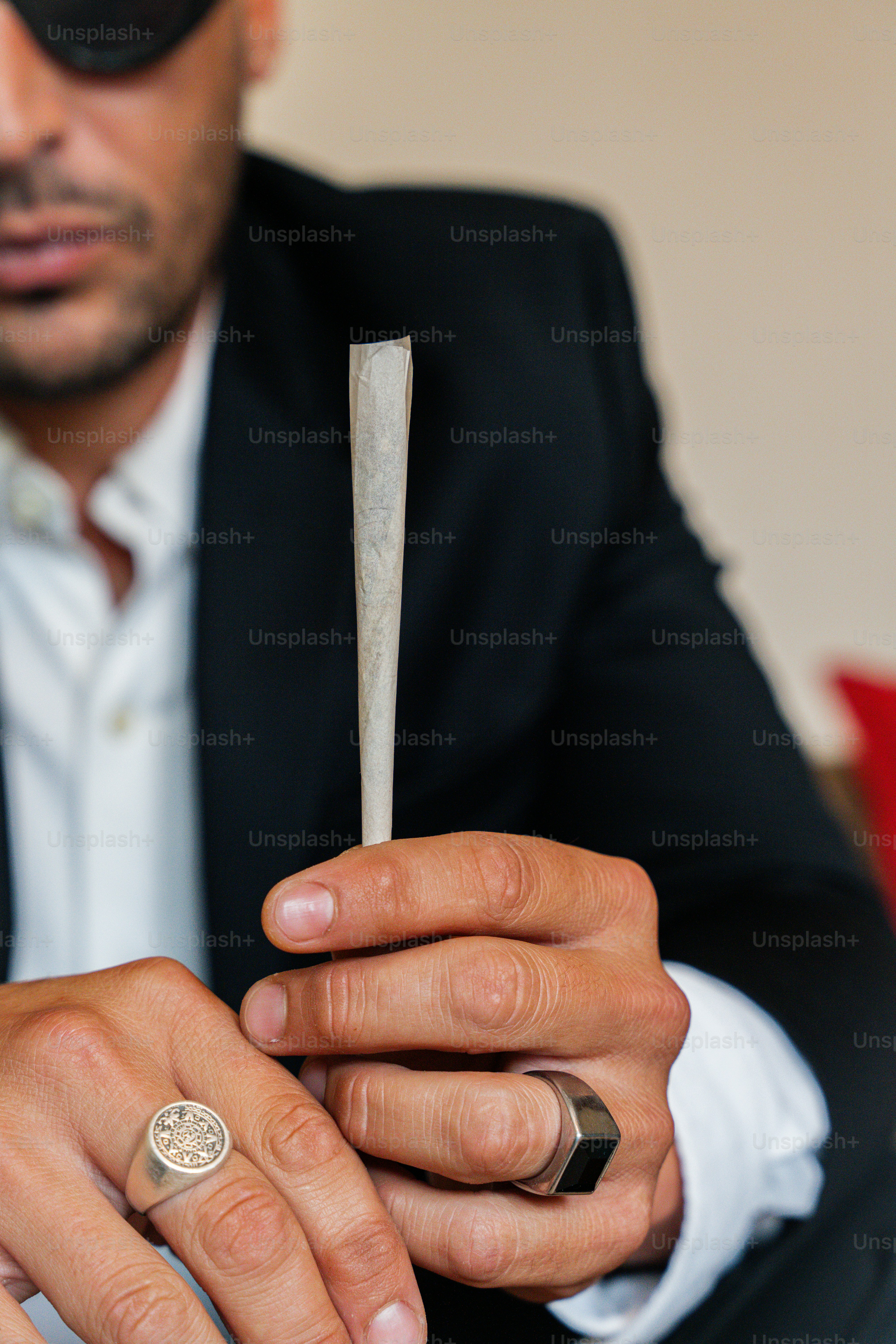 a man in a suit and tie holding a ring