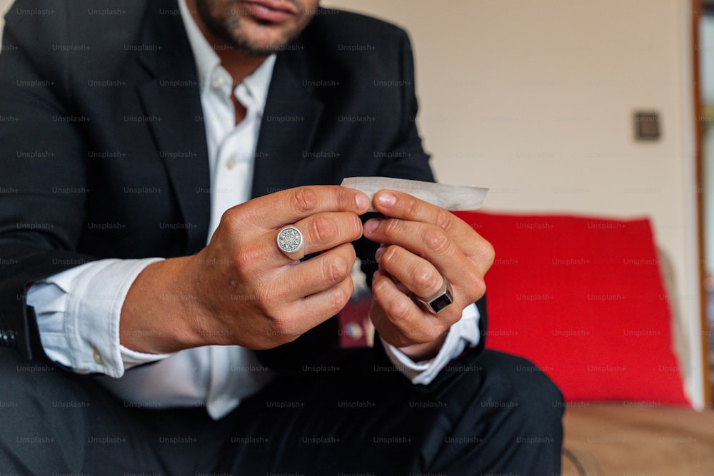 a man sitting on a couch holding a ring