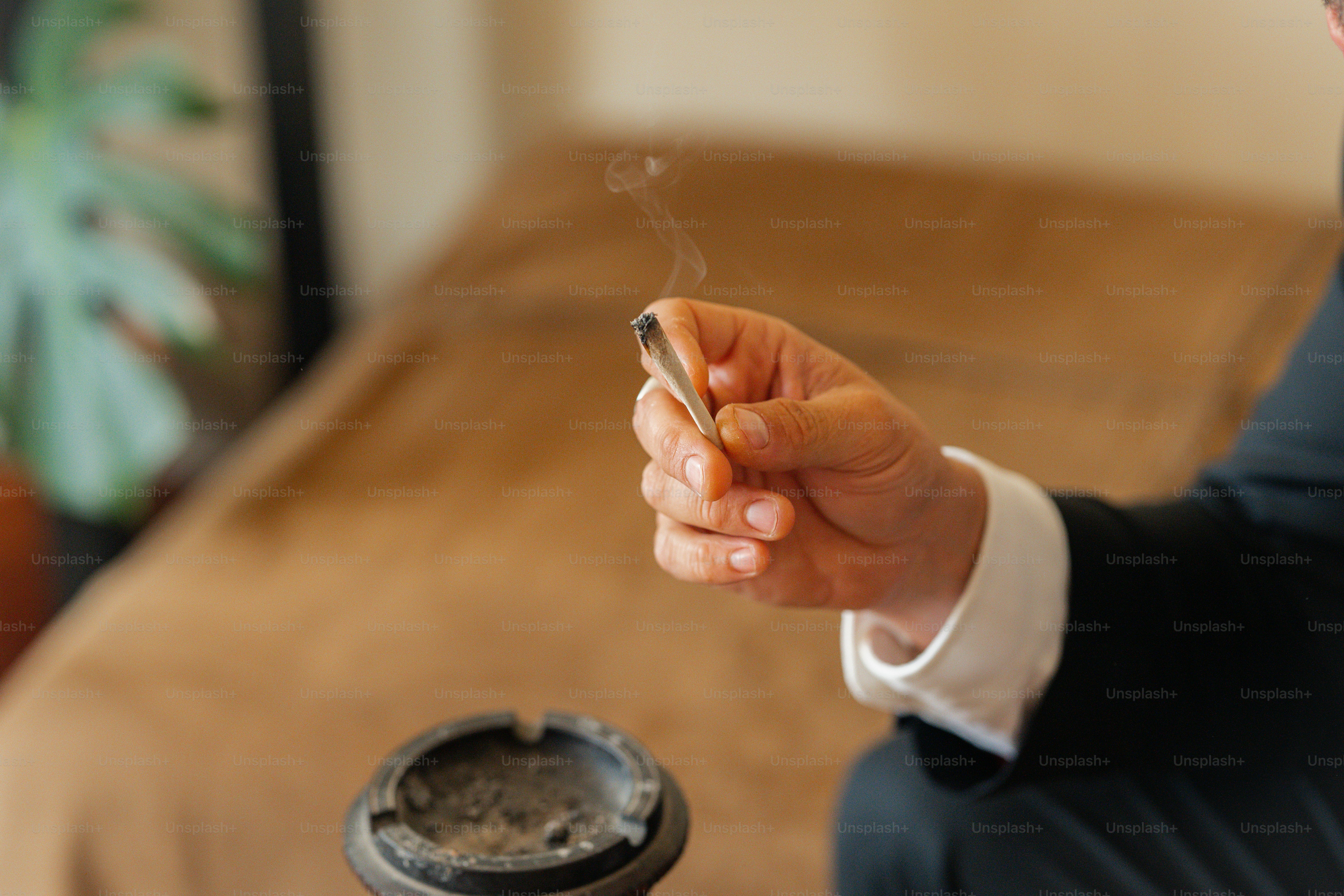 a man in a suit smoking a cigarette