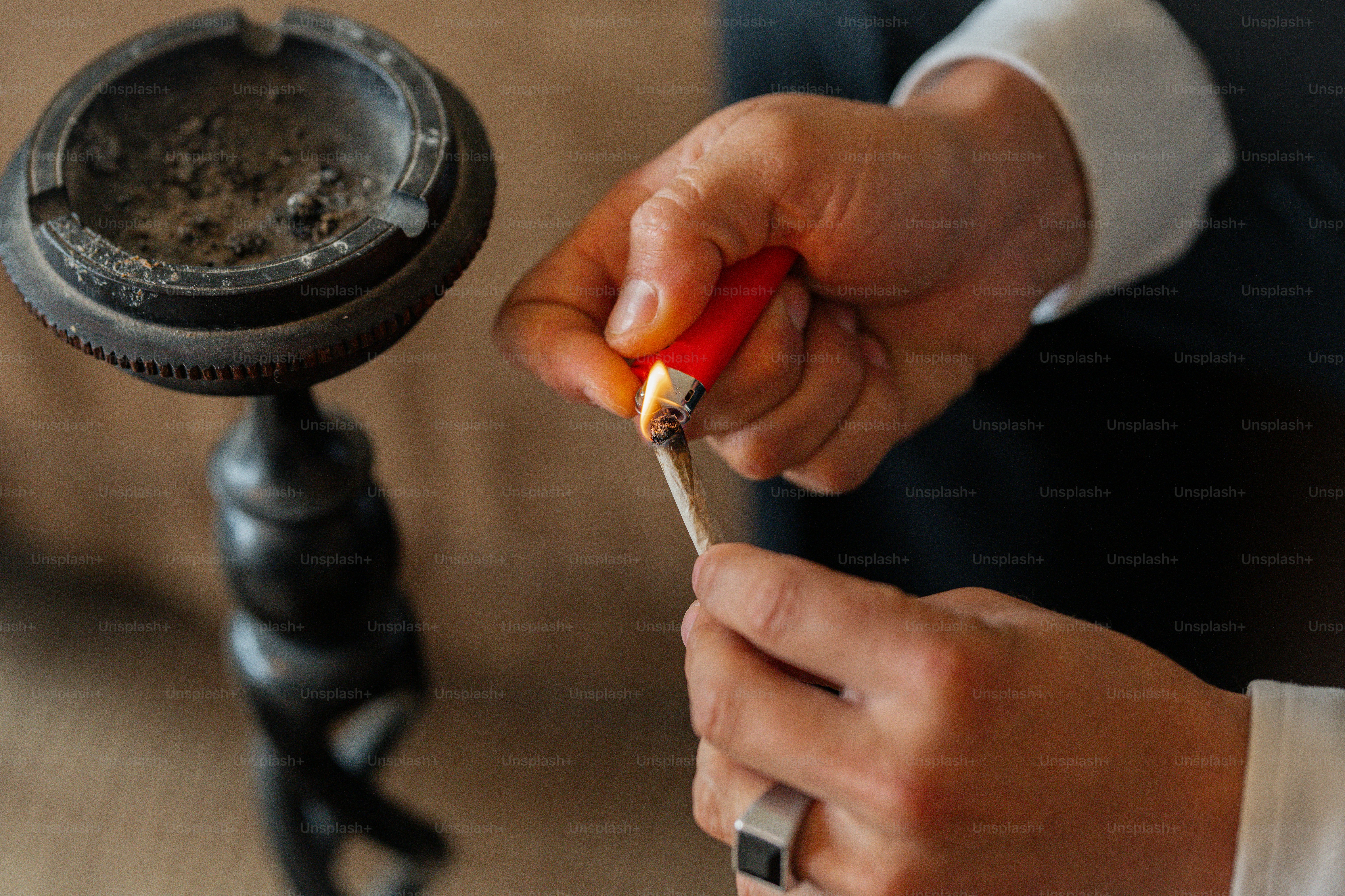 a person holding a cigarette in their hand