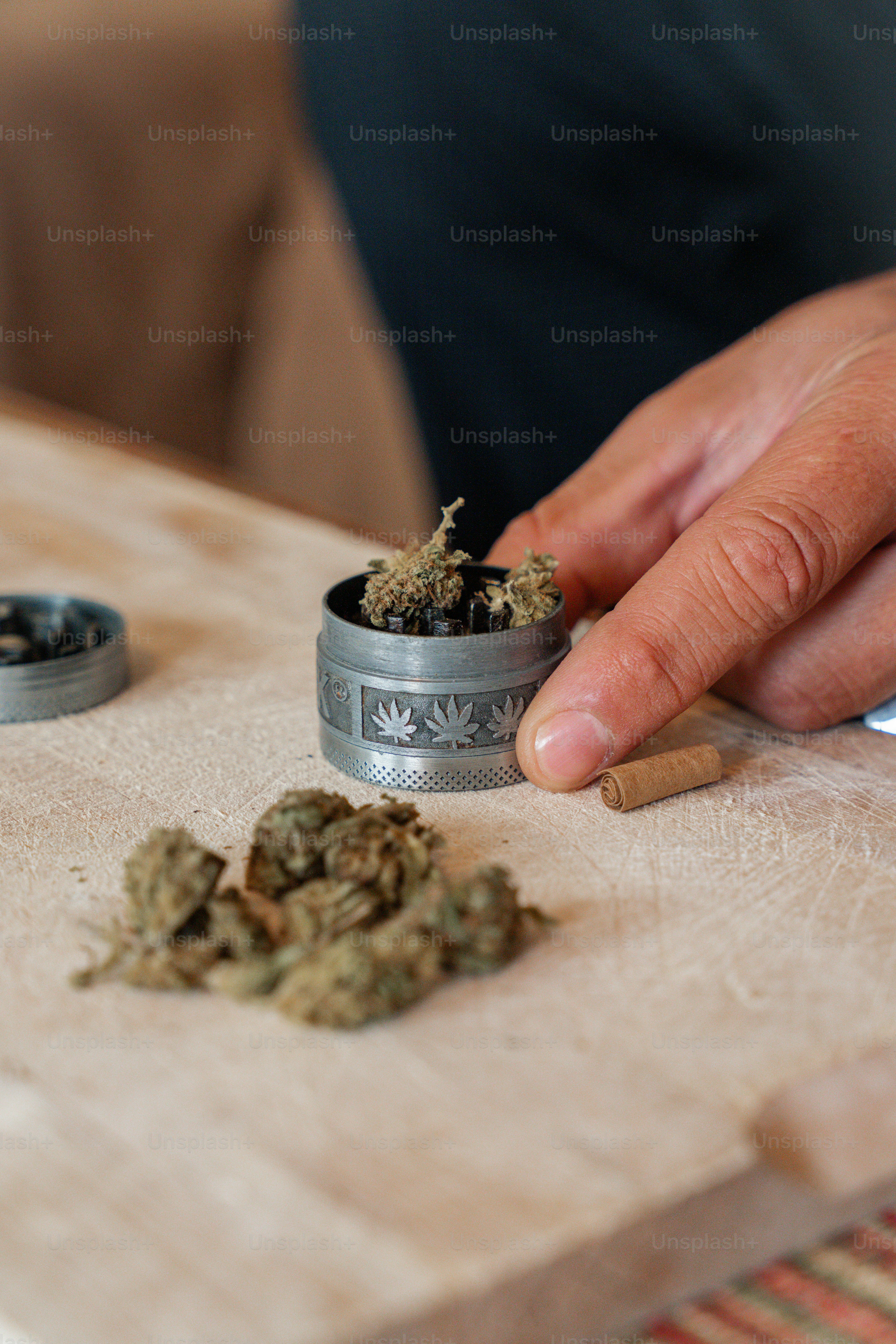 a person is putting a weed in a container
