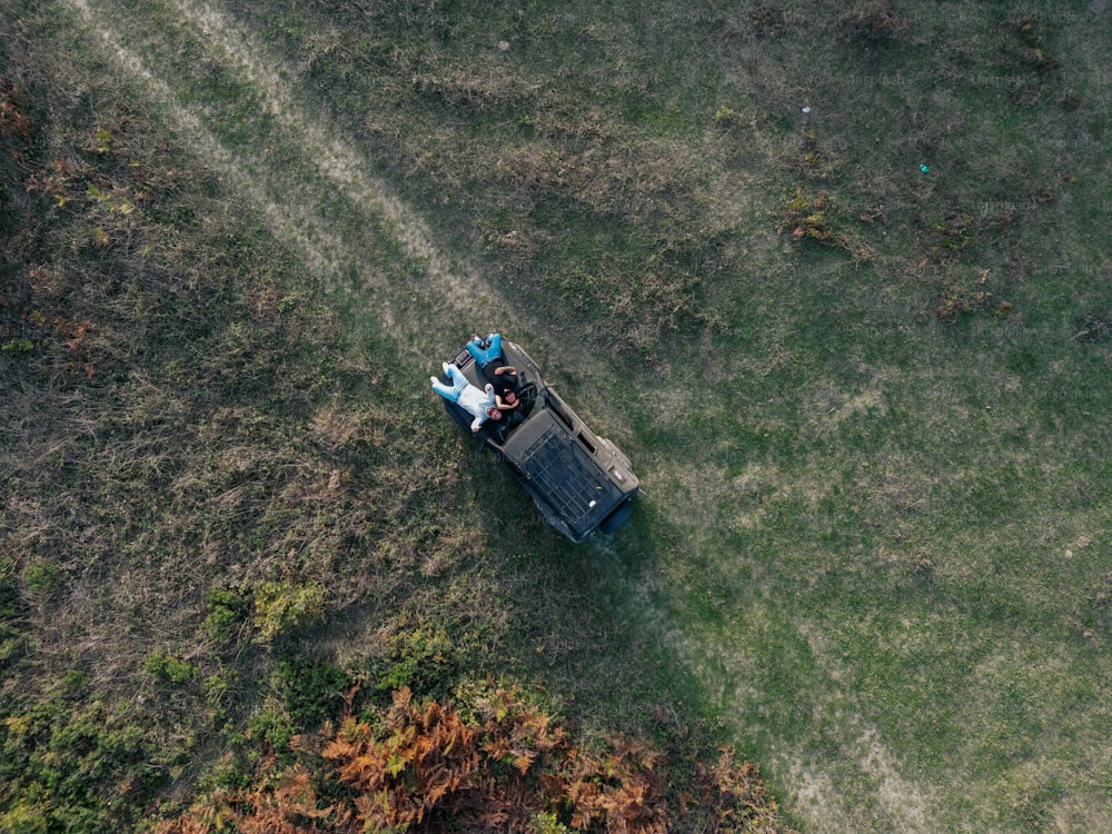 an aerial view of two people sitting on a truck