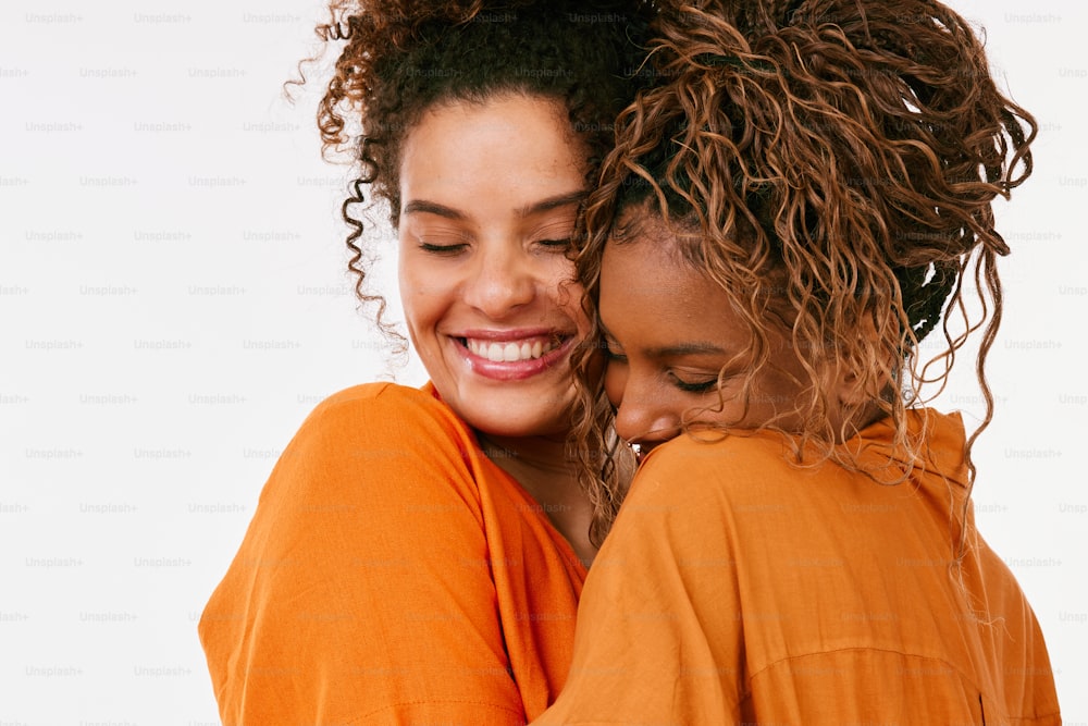 two women hugging each other and smiling