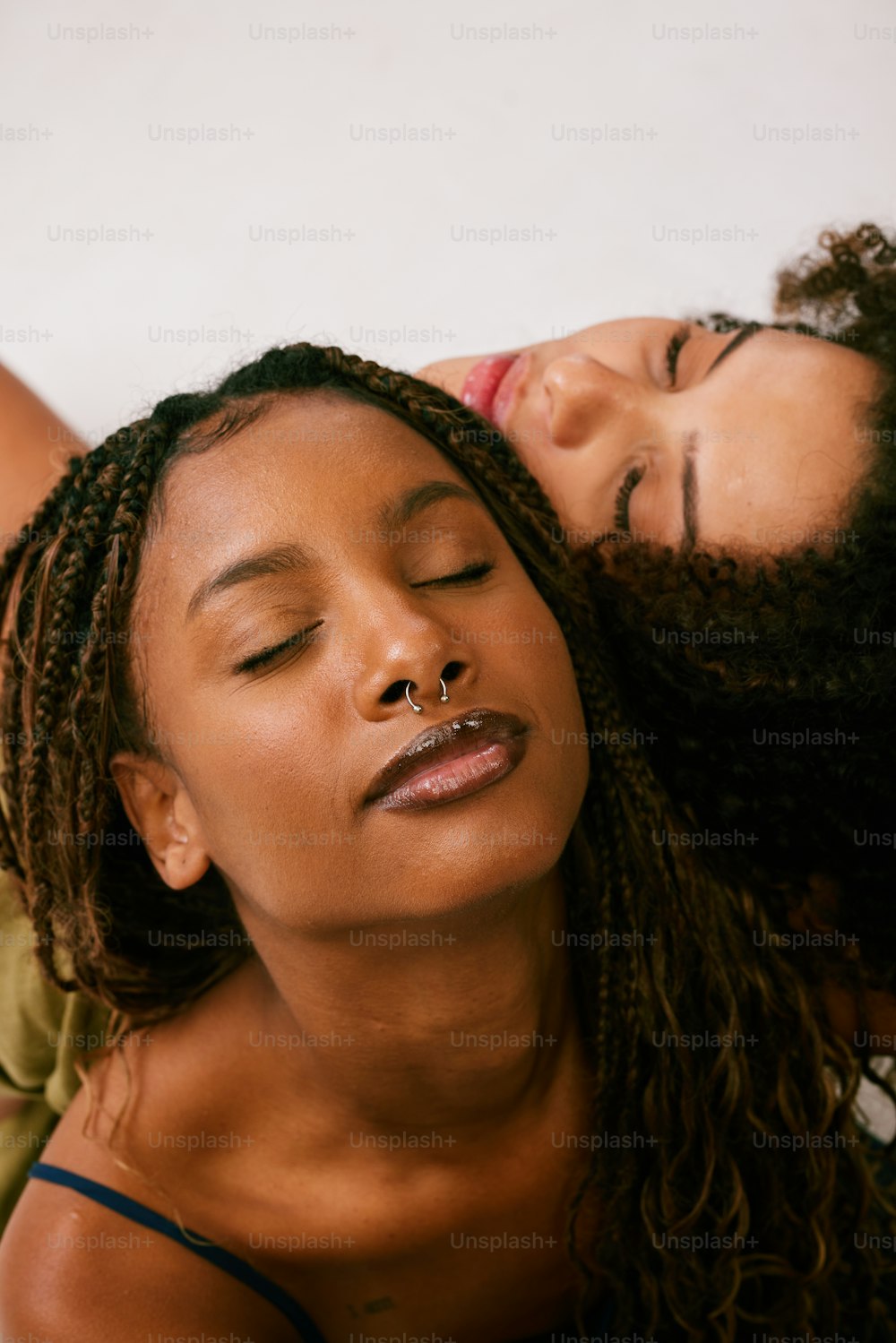 a couple of women laying next to each other