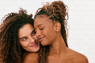 two beautiful young women hugging each other