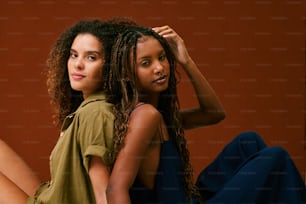 two beautiful young women sitting next to each other