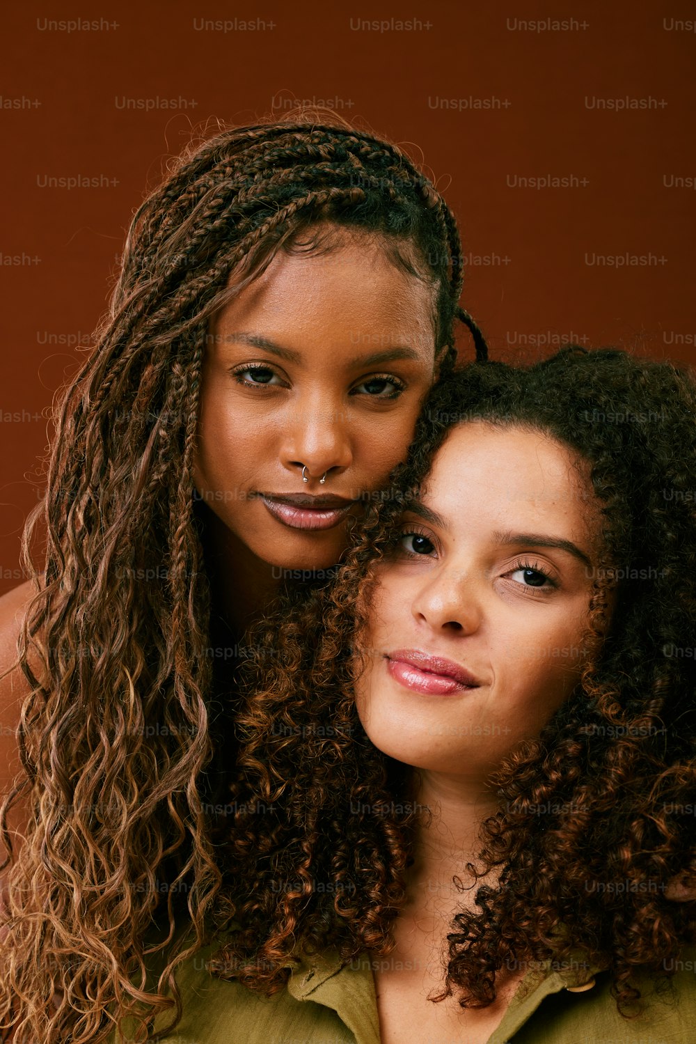 two beautiful young women standing next to each other