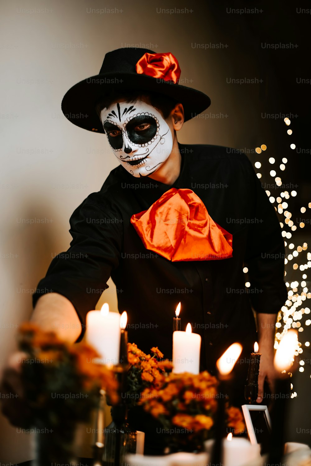 a man in a skeleton mask with candles