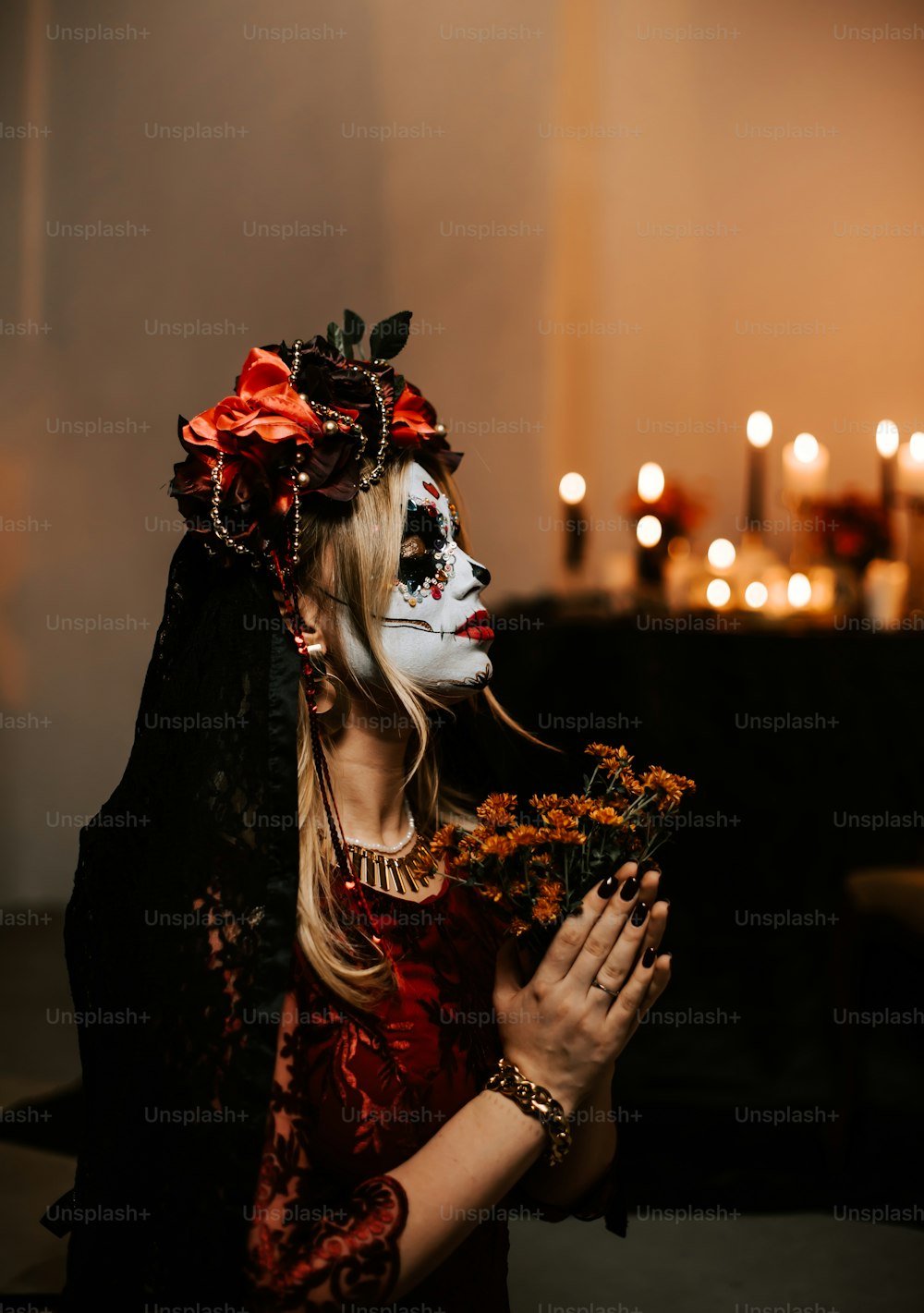 a woman in a skeleton mask holding a bouquet of flowers