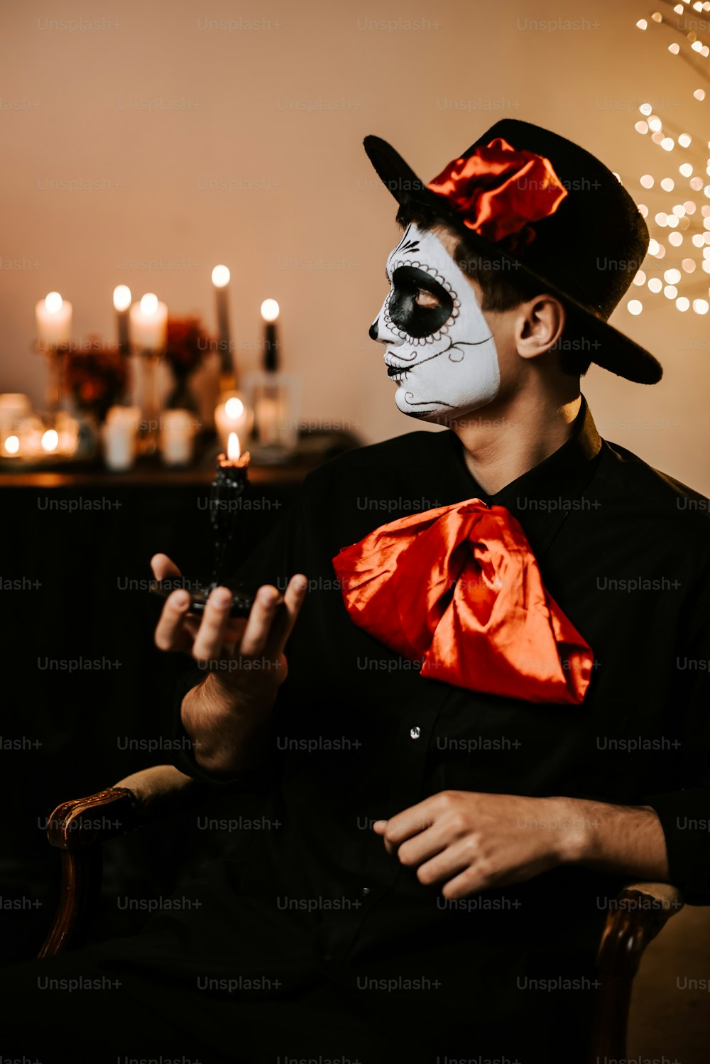 a man wearing a skeleton mask and a red bow tie