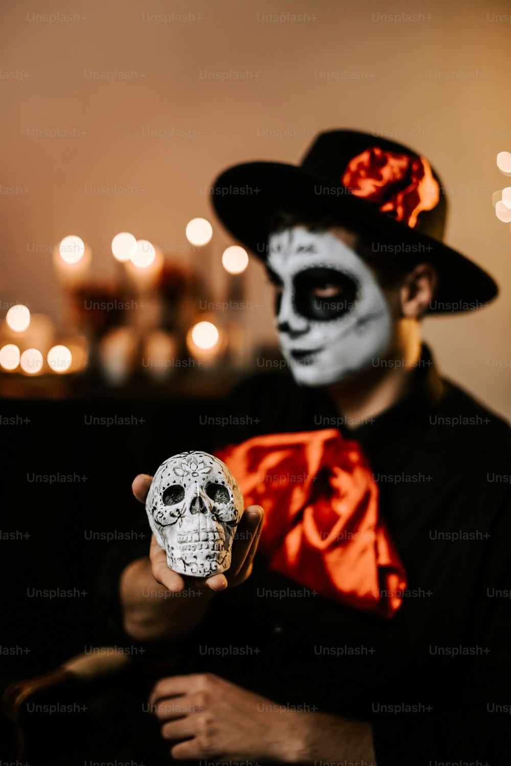 a man in a skeleton mask holding a skull