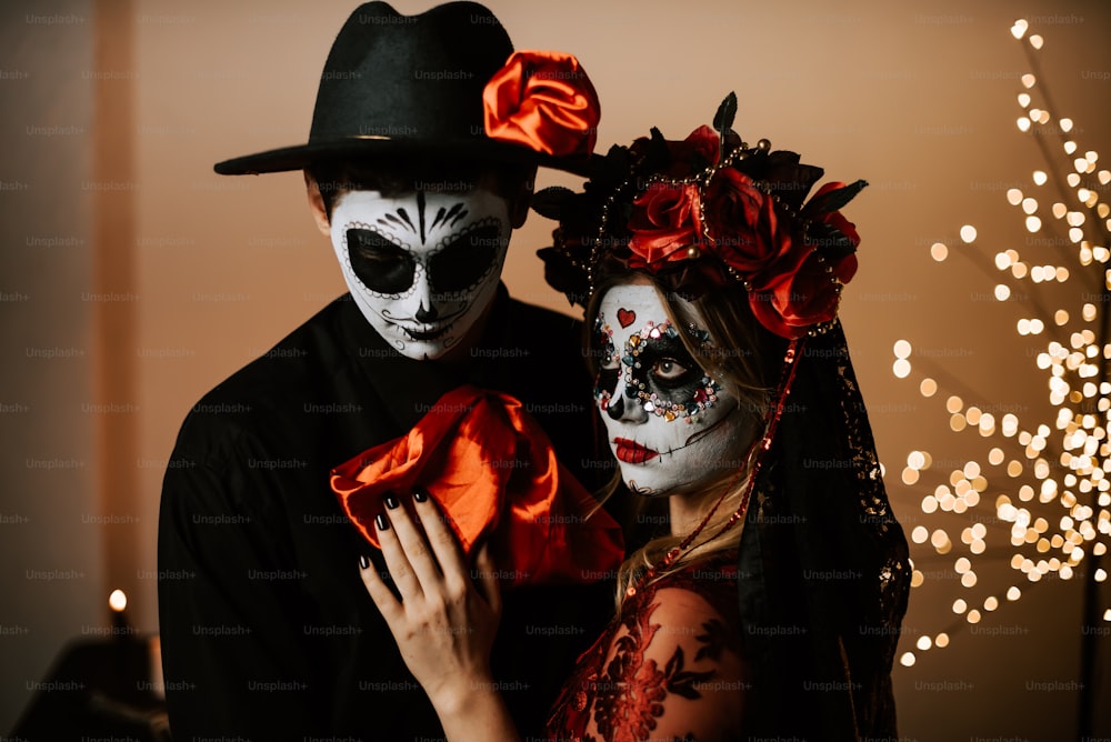 a man and a woman dressed up in skeleton makeup