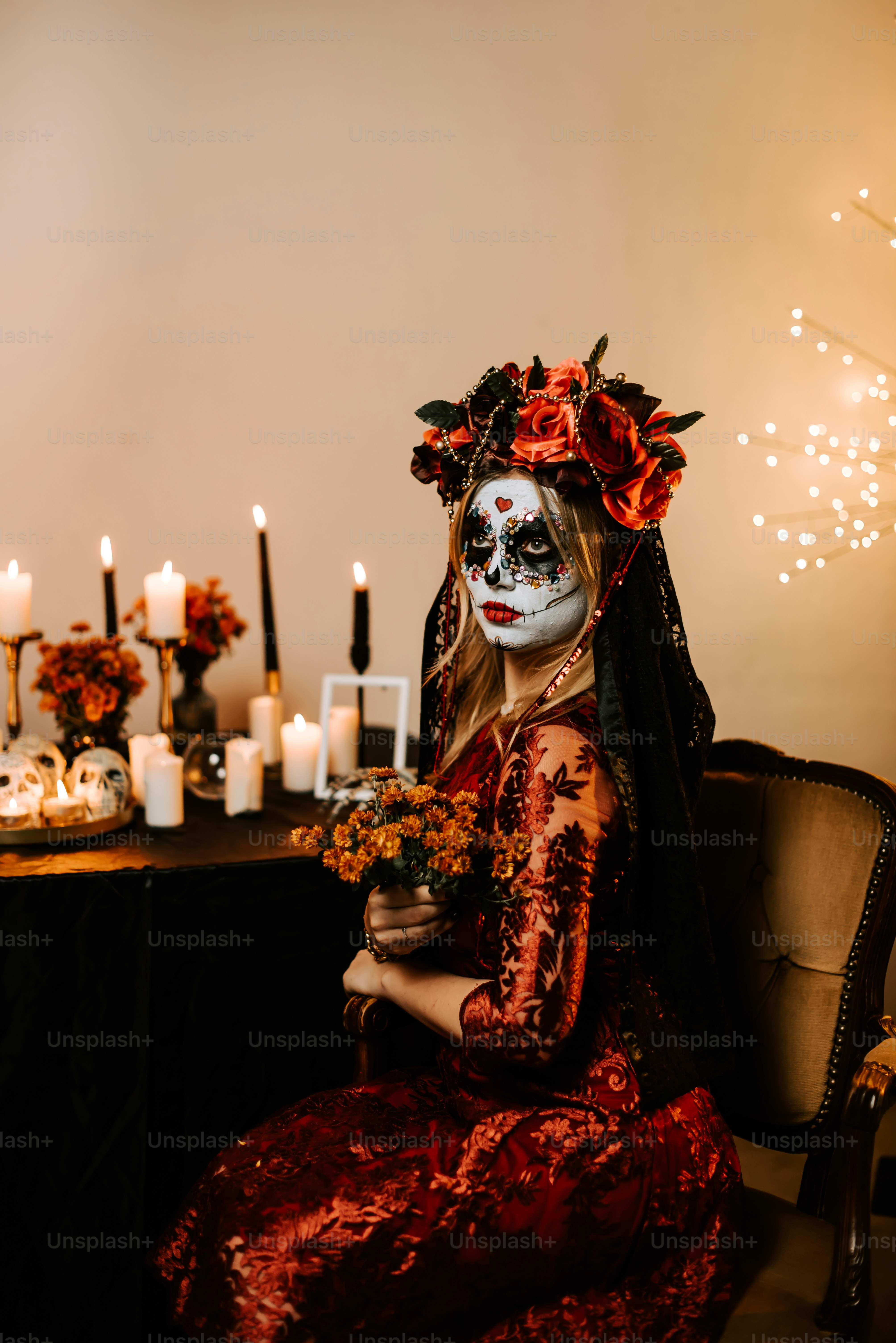 A man with a skeleton face paint sitting in a chair - Photo on Unsplash+