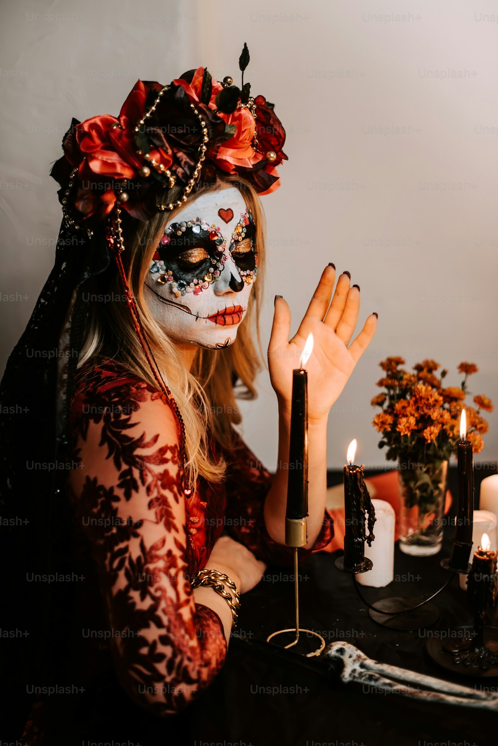 a woman with makeup and makeup art holding a candle