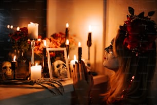 a woman wearing a skeleton mask and holding a candle