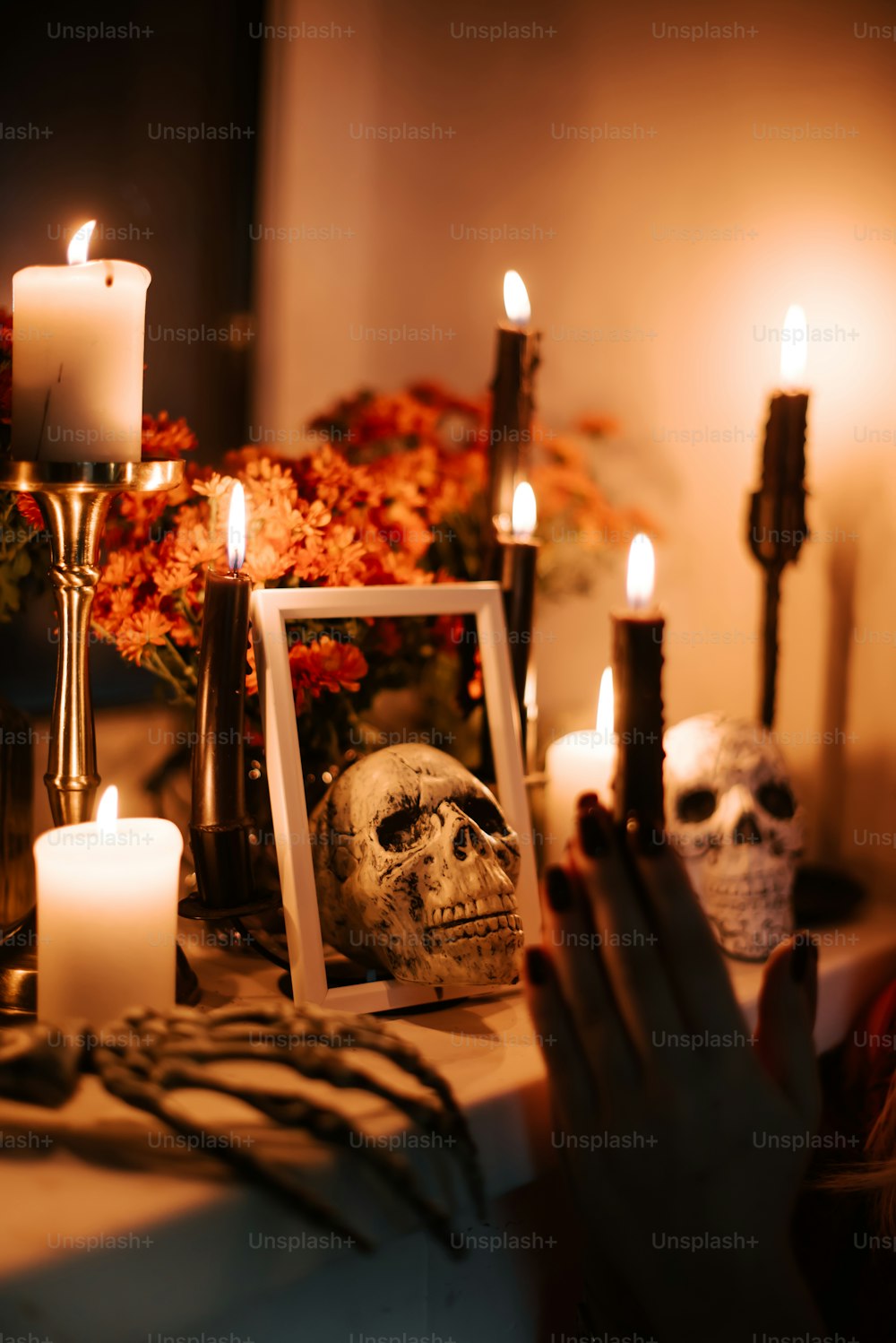 a table topped with candles and a picture of a skull