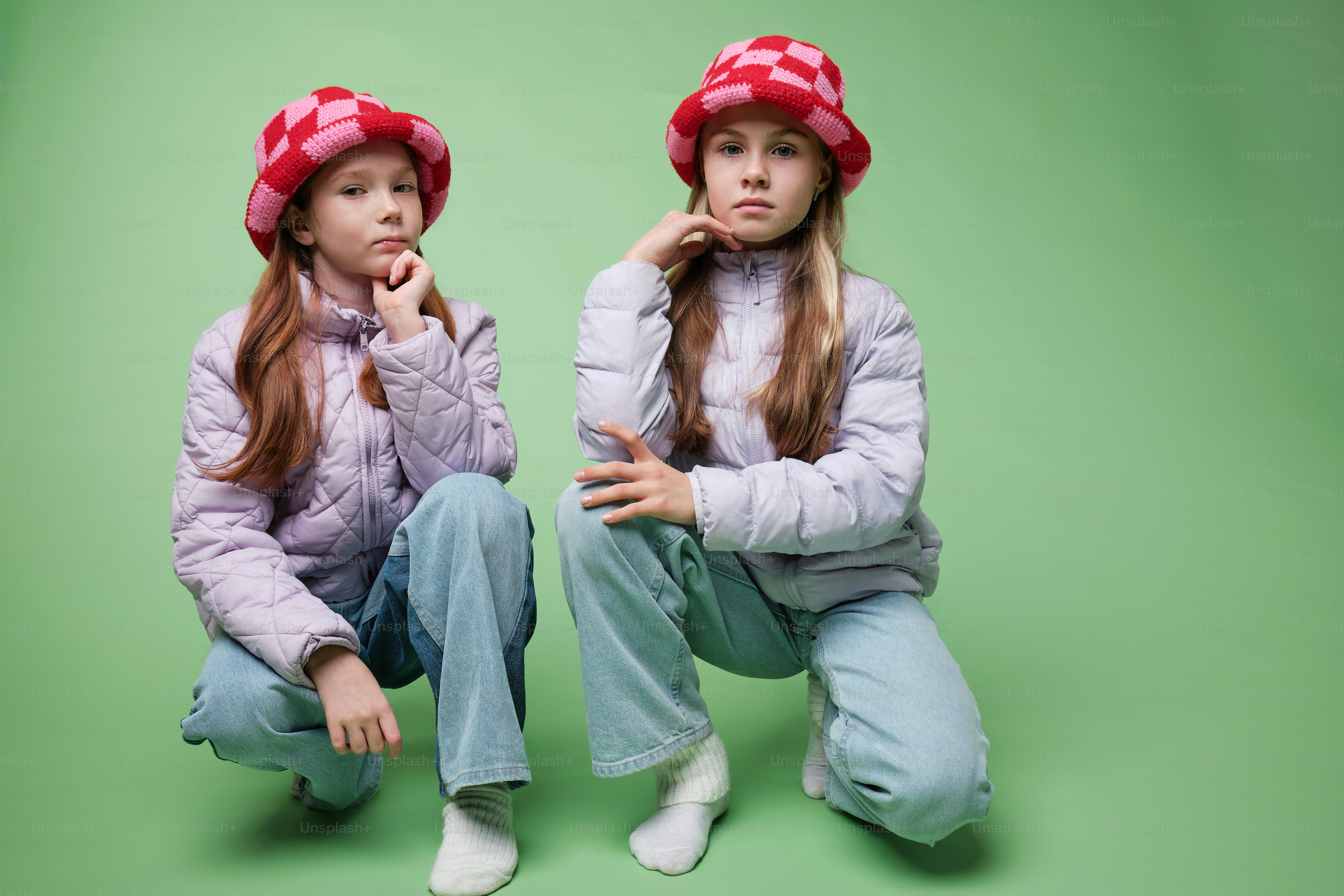 A two girls in autumn clothes on studio background in warm color scheme