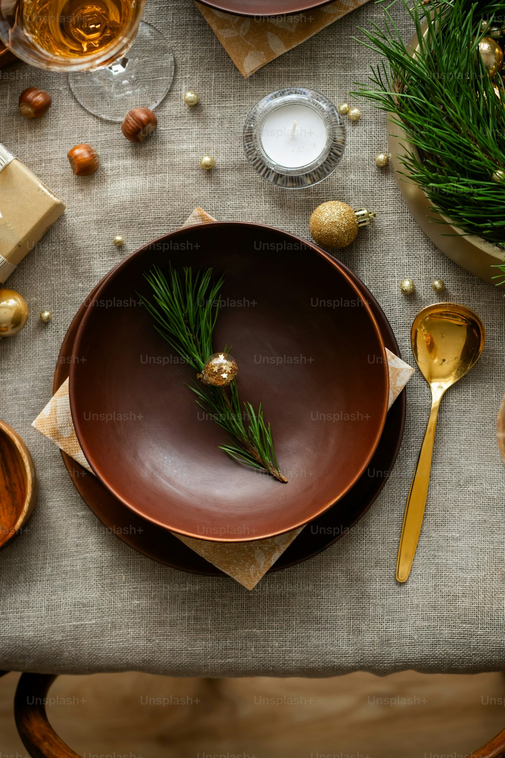 a table topped with a brown plate covered in a green sprig