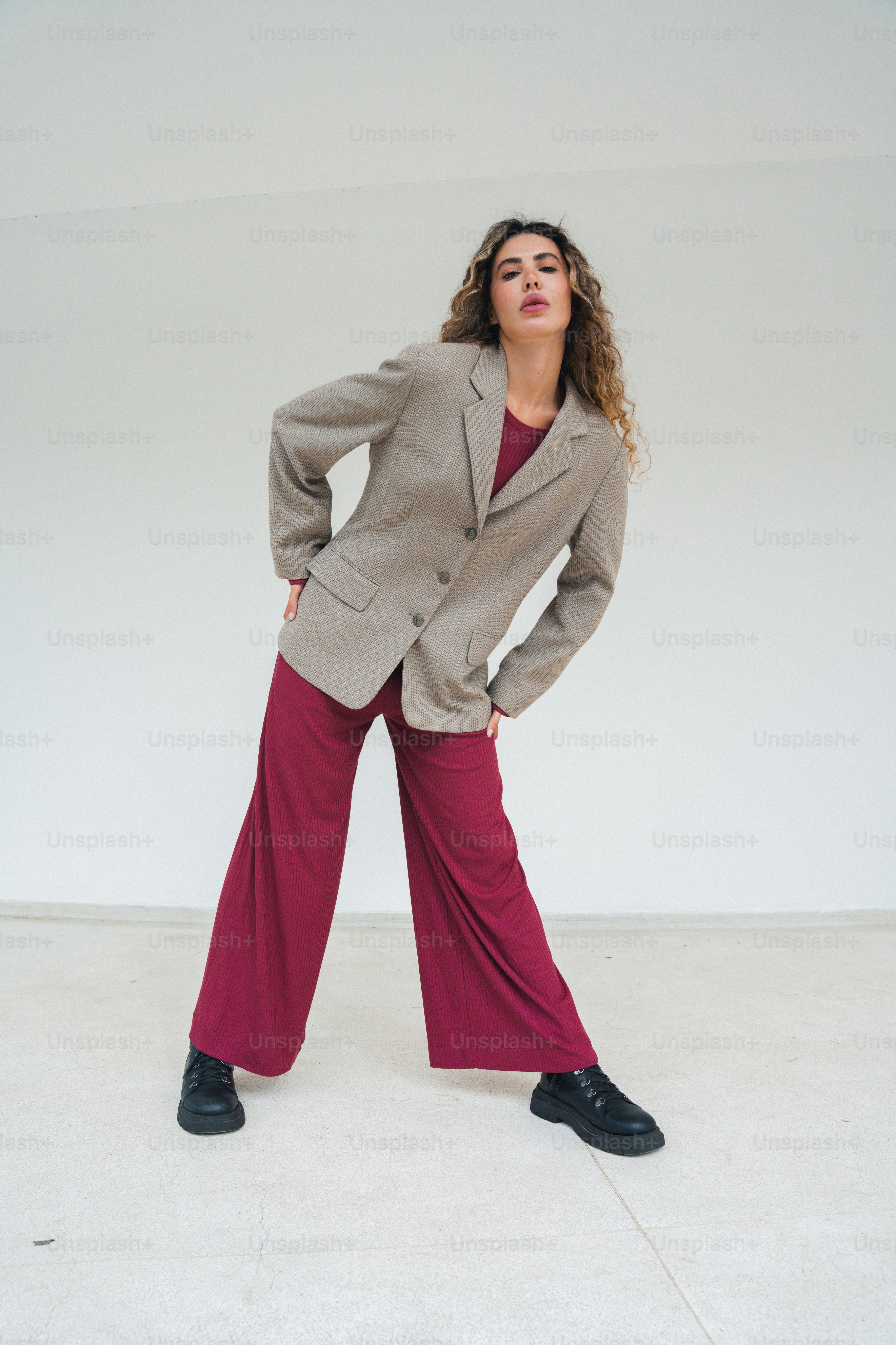 a woman standing in a room with her hands on her hips