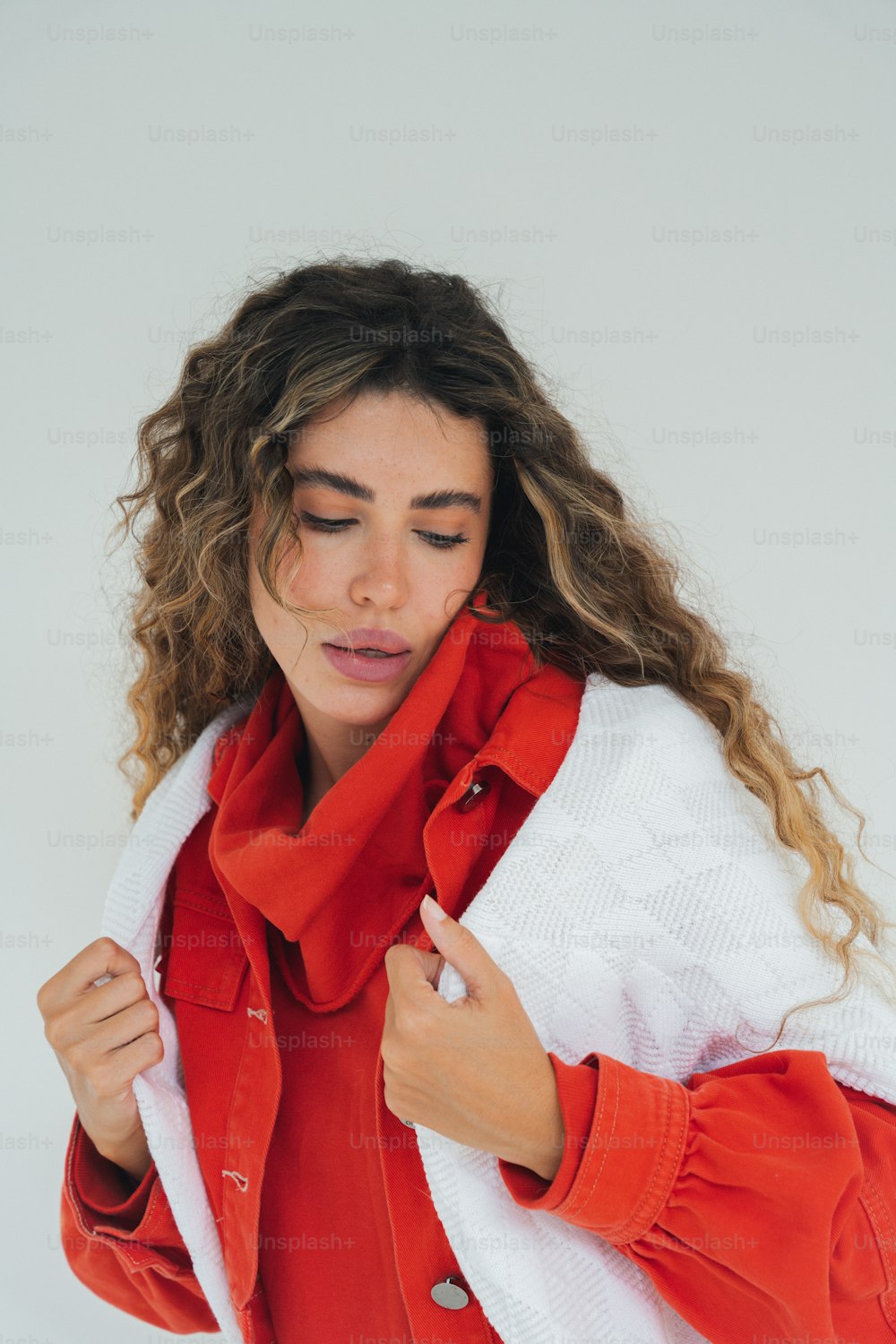 a woman wearing a red and white jacket and a red scarf
