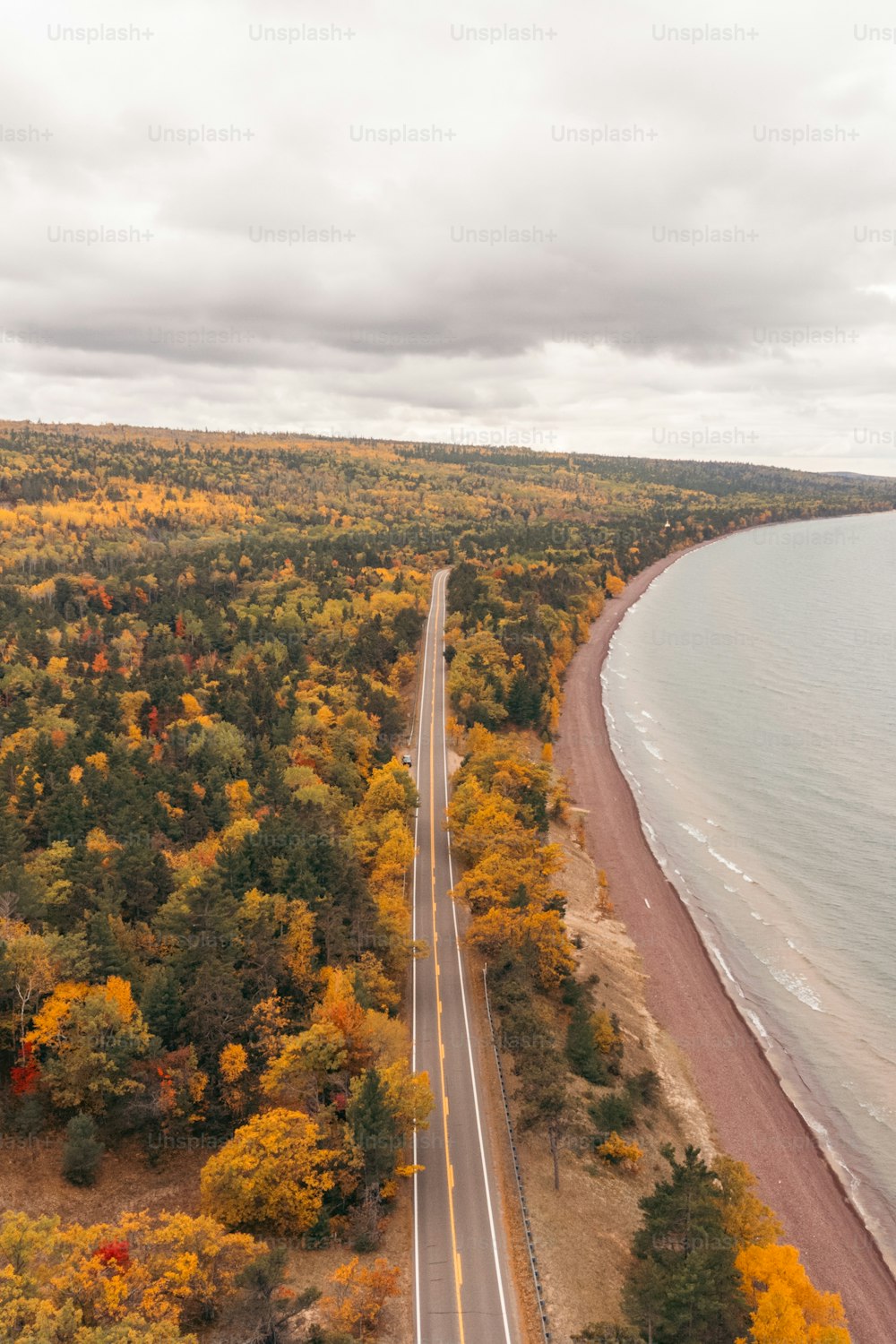 an aerial view of a road near the ocean