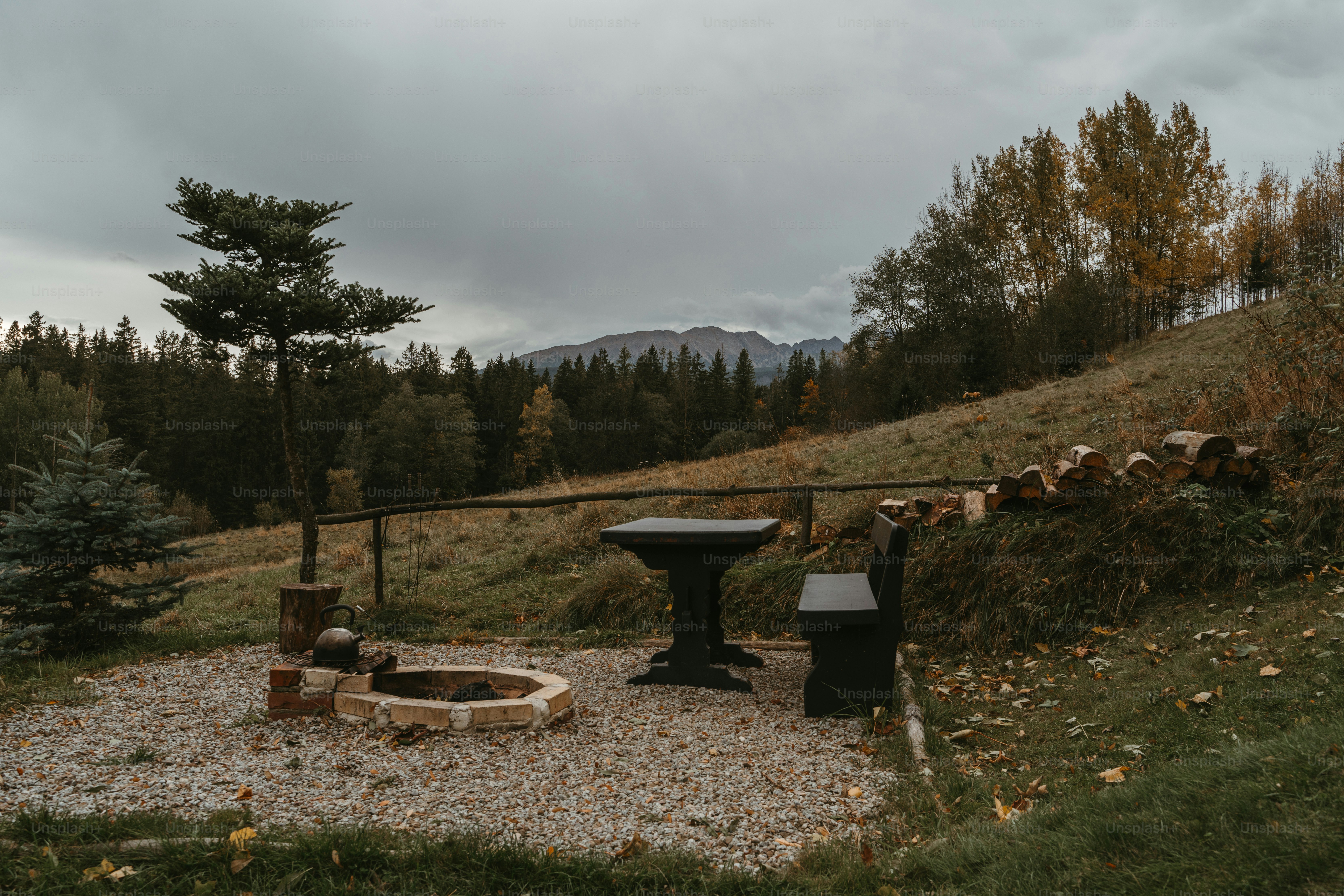 a fire pit sitting on top of a gravel field