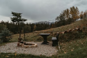 a fire pit sitting on top of a gravel field