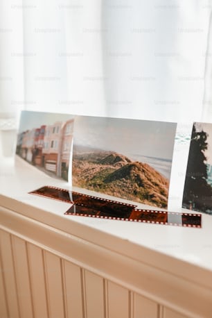 a window sill with three pictures on it