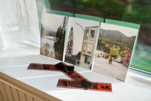 a window sill with three pictures on it