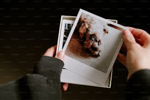 a person holding up a picture of a dog